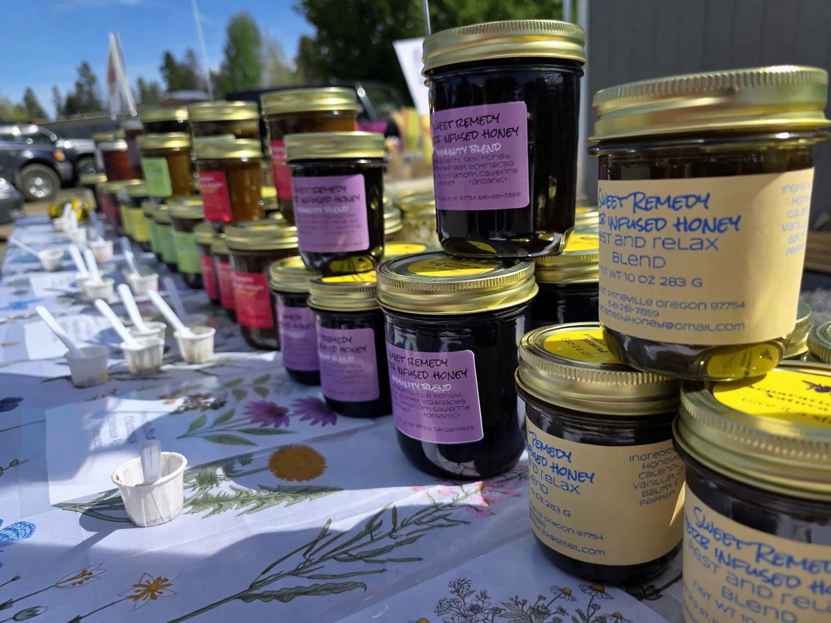 Sweet Remedy Honey jars on a wood surface